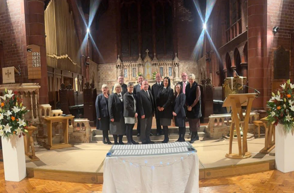 A personal celebration of life ceremony with floral tributes in North Wales